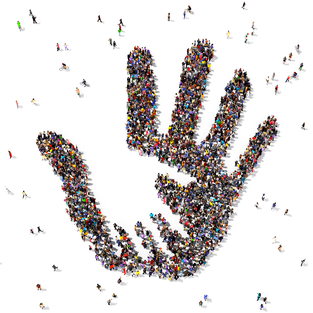 Caring hand symbol formed out of people seen from above, on white background